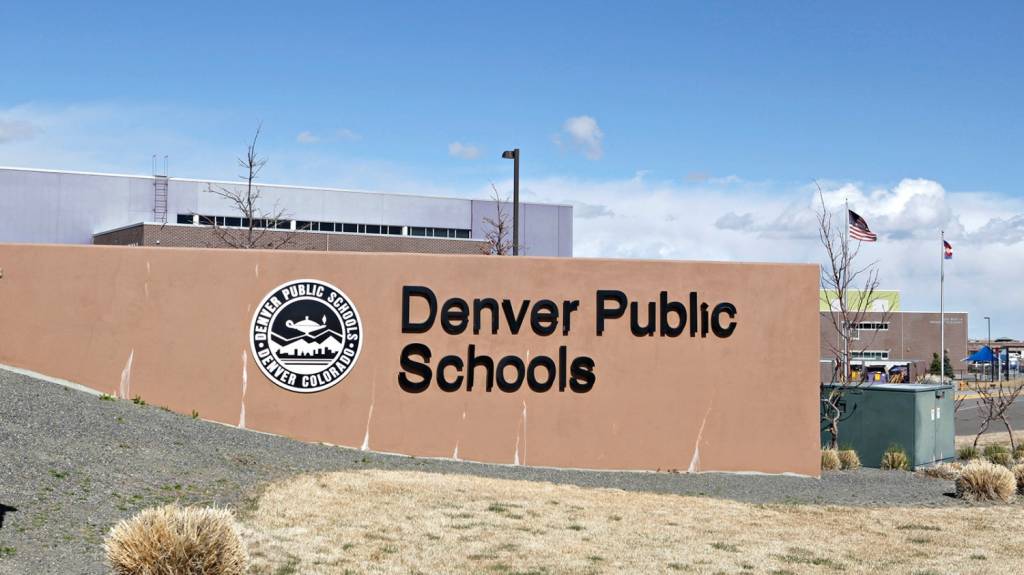 A photo of the Denver Public Schools crest on a school wall