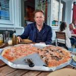 A photo of Eddie Morgan enjoying a huge pizza