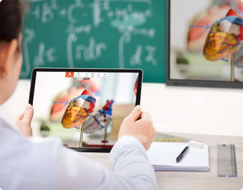 A young student sharing their device to the big screen in a classroom