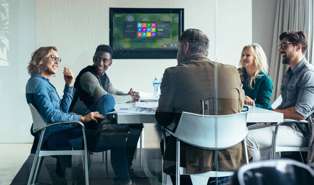 Employees in a meeting room using DisplayNote Launcher on the main screen