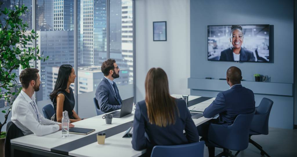 Group of business people video conferencing using high quality meeting room technology